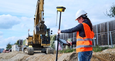 Woman checking grade with the Leica iCON gps 160 smart antenna