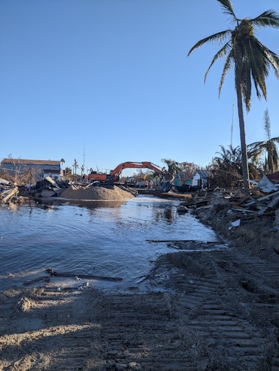 Hurricane Ian emergency repair Pine Island Florida land access excavator working