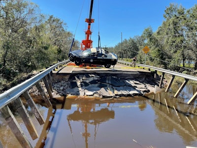 Hurricane Ian Florida Highway Patrol cruiser lifted by crane at sight of washed out road Hardee County