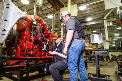 WyoTech student and instructor working on a diesel engine