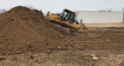 Iacoboni Site Specialists Cat dozer pushing dirt onto dirt pile