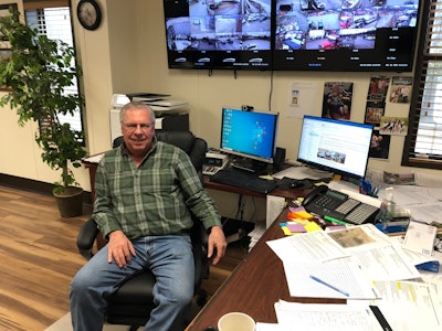 Iacoboni Site Specialists Vice President Bill Francik sitting at desk with computer and overhead monitors