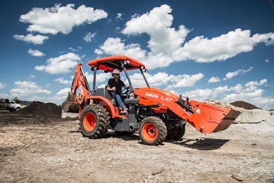 Kubota L47 Tractor Loader Backhoe carrying a load of aggregate