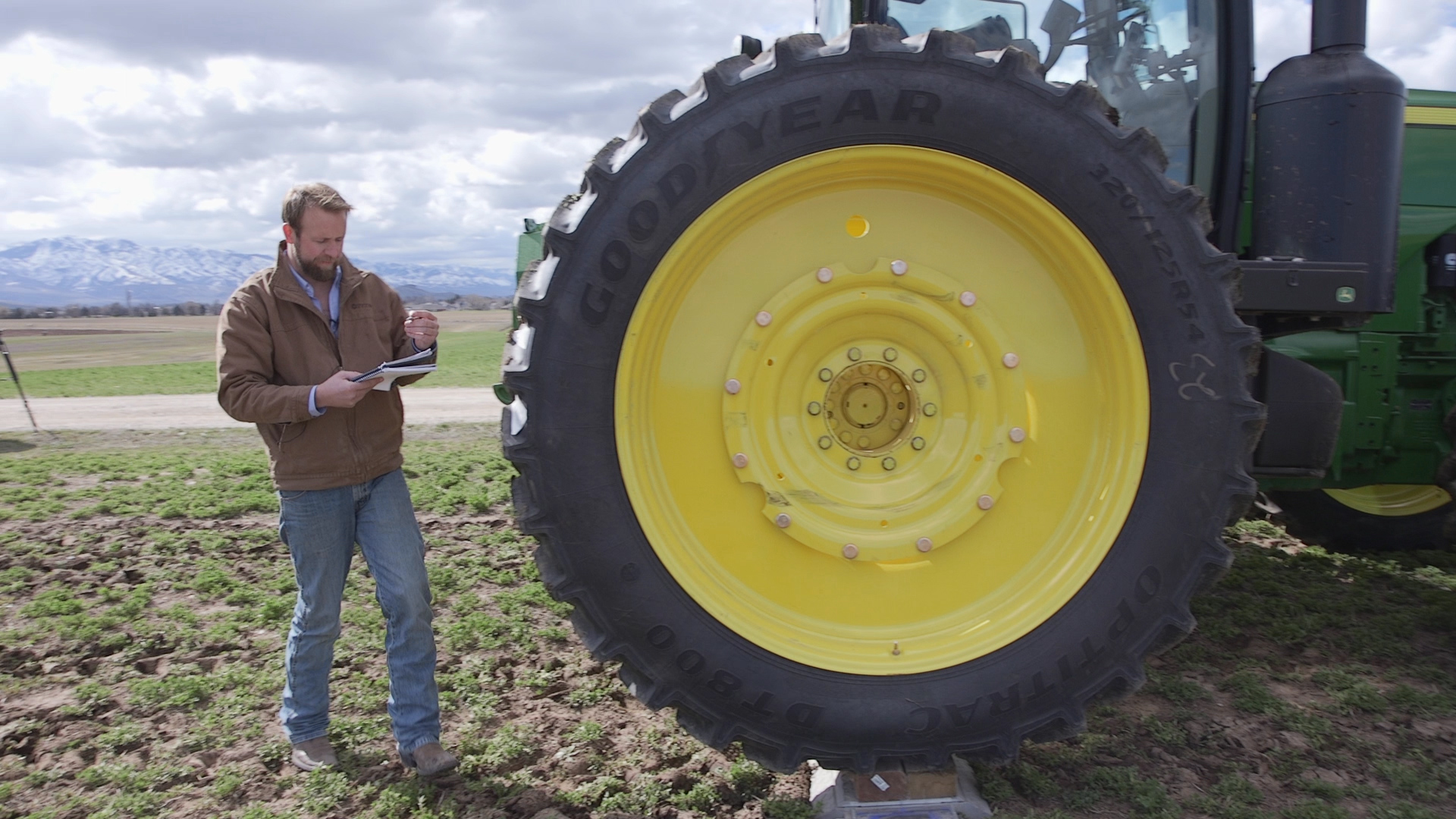 Man checking tractor weight