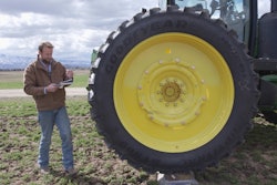 Man checking tractor weight