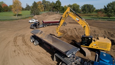 Cat 340 hydraulic excavator loading a truck