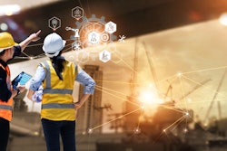 male and female construction workers looking at digital design
