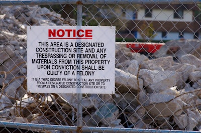 Construction site no trespassing sign on fence