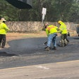 Hawaii paving crew smoothing asphalt on road