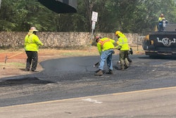 Hawaii paving crew smoothing asphalt on road