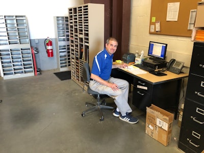 Highway Equipment & Supply parts manager at desk