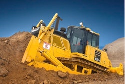 Komatsu D85EX-8 dozer pushing dirt up dirt pile