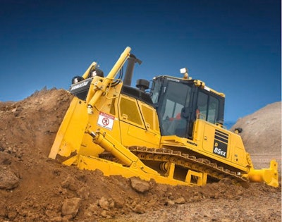 Komatsu D85EX-8 dozer pushing dirt up dirt pile