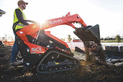 Kubota SCL1000 compact utility loader dumping dirt on construction site