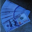 100 dollar bills spread out to illustrate Caltrans bribery and bid-rigging scheme