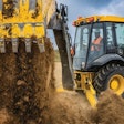 Deere X-Tier Backhoe dumping dirt