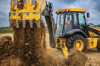 Deere X-Tier Backhoe dumping dirt