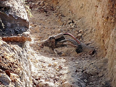 DIRT report utility strikes stock photo open high voltage cable in dirt trench