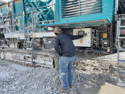 Darian Houssain tweaking settings on a crushing machine