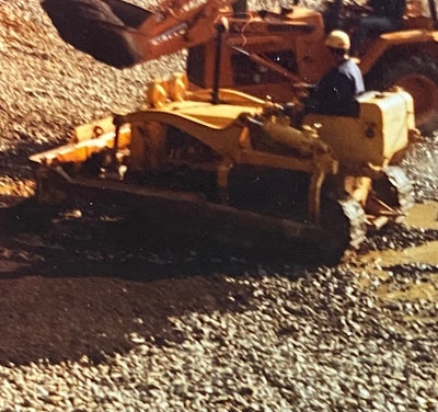 yellow International TD-6 dozer operating in muddy wet conditions
