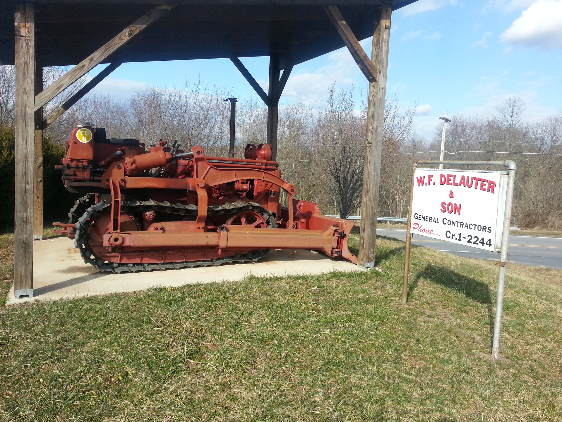 red 1954 International TD-6 dozer under wooden shelter