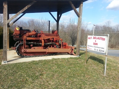 red 1954 International TD-6 dozer under wooden shelter