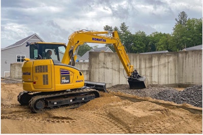 Komatsu PC78US-11 excavator scooping gravel