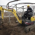 Wacker Neuson EZ17 compact excavator digging beside and under frame structure