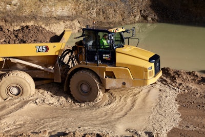 Cat 745 articulated dump truck in thick mud carrying dirt load