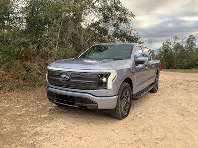 Ford F-150 Lightning parked in dirt area