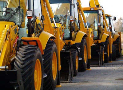 Backhoe loaders parked in a row