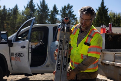 Technician of the year Robert Kesselring carries a ladder at jobsite