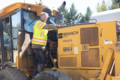 Technician of the year Robert Kesselring standing on a Branch Civil motor garder