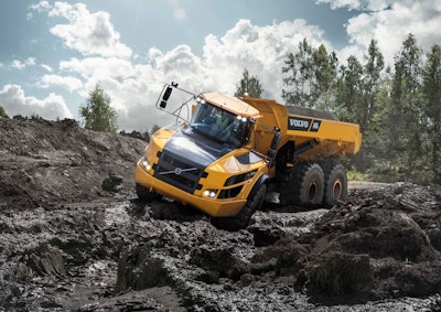 Volvo A40G articulated dump truck cab tilted down slogging through thick black mud