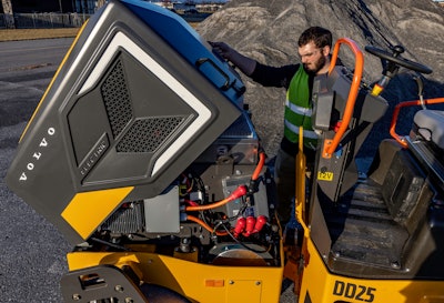 John Rouse looking under the hood of Volvo DD25 Electric