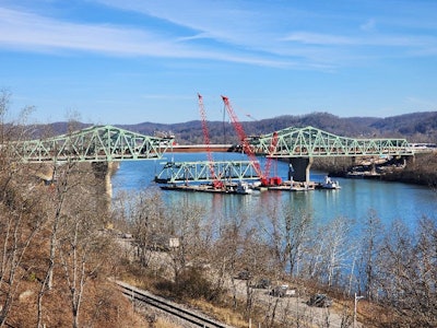 main span of Legg Memorial Bridge in West Virginia lowered onto barges to be recycled