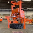 orange LiftWise Hanging Tire Handler with large tire clamped