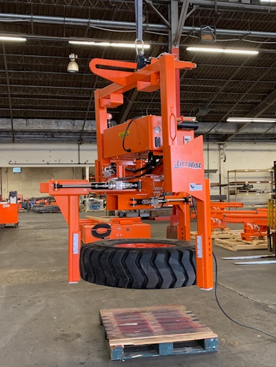 orange LiftWise Hanging Tire Handler with large tire clamped