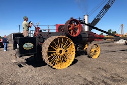 1918 Russell steam tractor running belt to drive old-time rock crushing demonstration