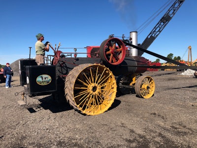 1918 Russell steam tractor running belt to drive old-time rock crushing demonstration