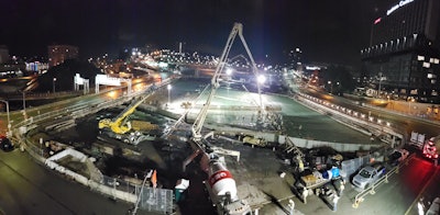 night time aerial view of work to build park over I-579 in Pittsburgh