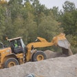 Caterpillar 962 next generation medium wheel loader dumping dirt
