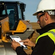 Construction worker accessing Cat SIS2GO app on a tablet