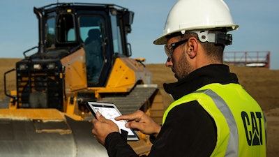 Construction worker accessing Cat SIS2GO app on a tablet