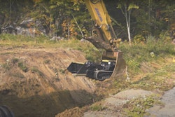 Movex Track-O M-47 Minidozer lowered into trench in excavator bucket