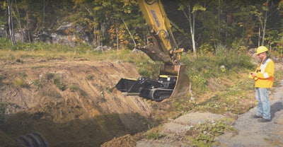 Movex Track-O M-47 Minidozer lowered into trench in excavator bucket