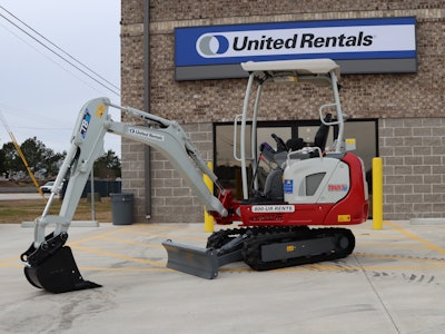 Takeuchi TB20e electric compact excavator in front of United Rental loading dock