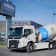 Volvo electric FMC concrete mixer in front of Volvo building