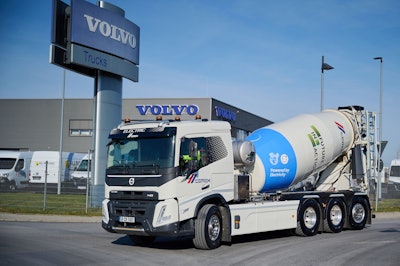 Volvo electric FMC concrete mixer in front of Volvo building