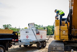 worker refilling excavator from Western Global TransCube